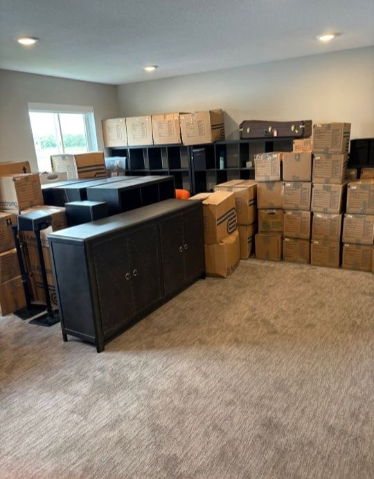 Full home move with boxes and furniture organized in new room — Carrollton, TX