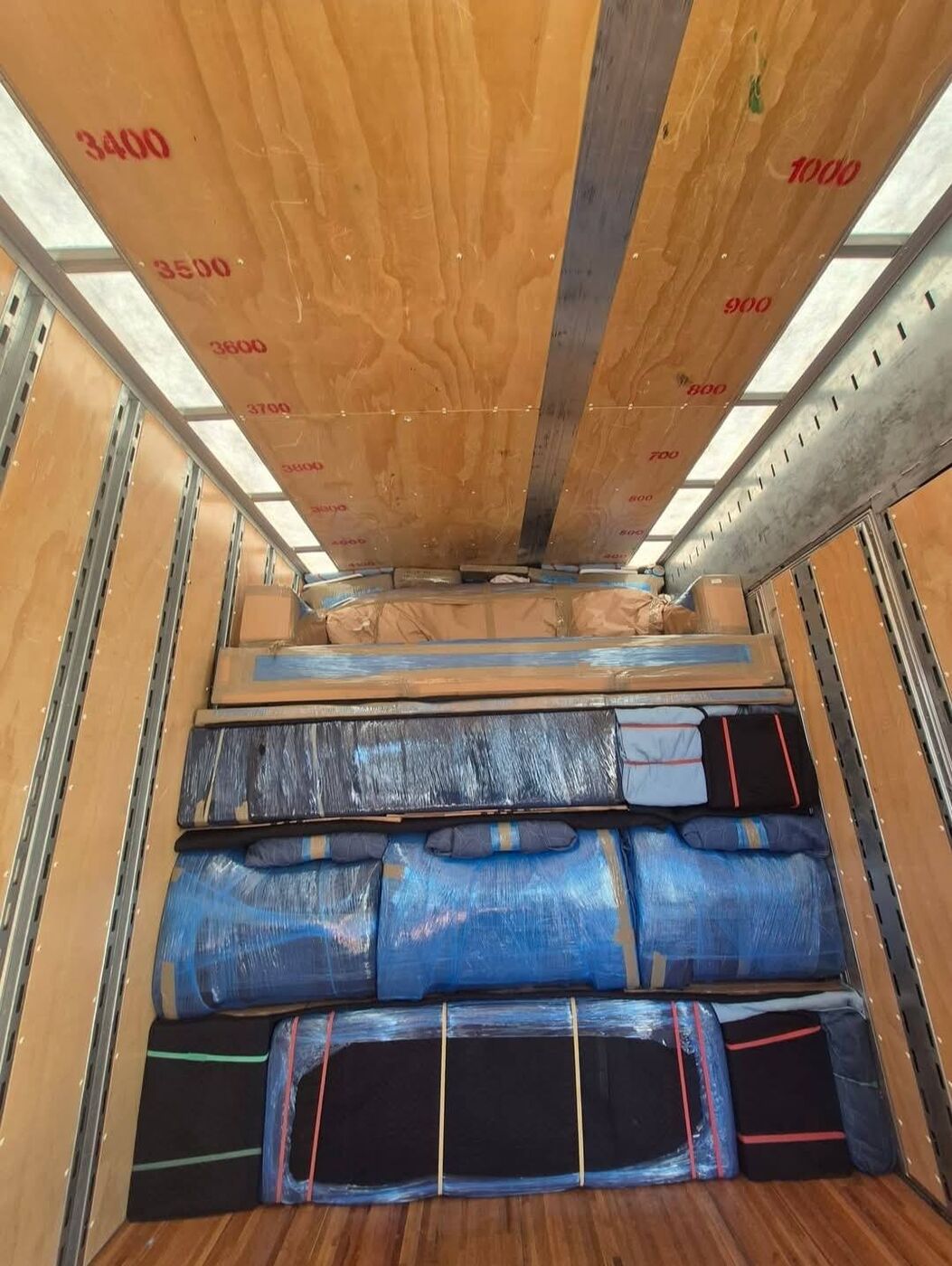 Moving truck fully loaded with blanket-wrapped furniture — DFW professional movers