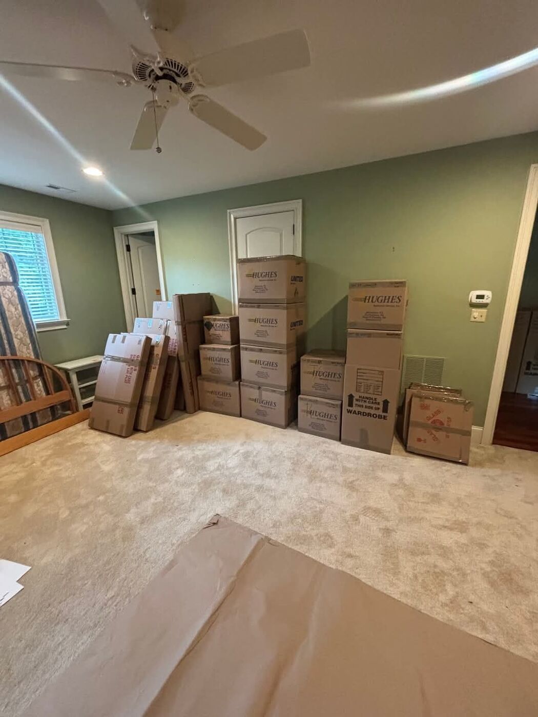 Bedroom with stacked wardrobe and moving boxes organized and ready for move day — One World Van Lines Keller, TX DFW professional movers