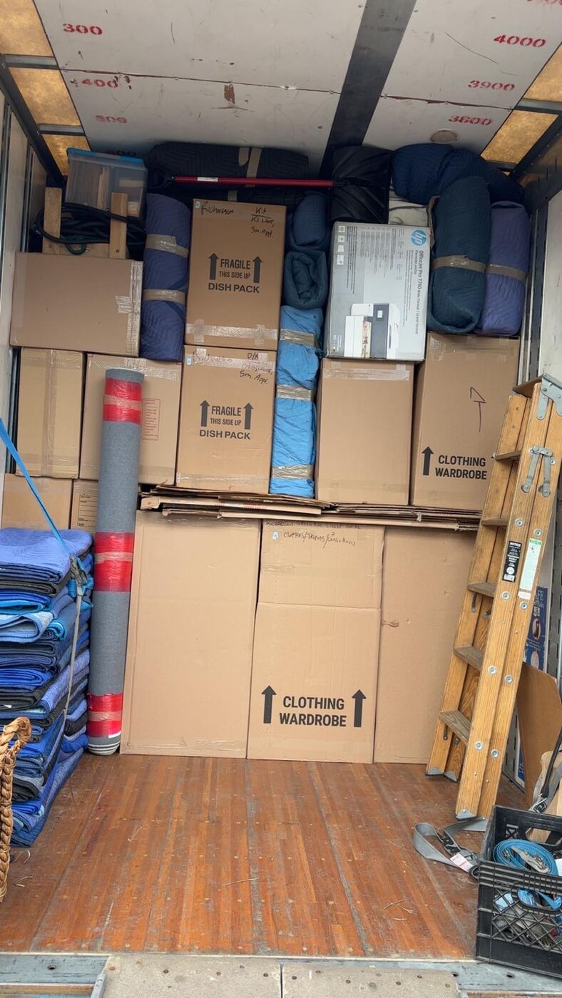 Moving truck with dish-pack fragile boxes, wardrobe clothing boxes, rolled rugs, HP printer box and wooden ladder — One World Van Lines Southlake, TX DFW Metroplex professional movers
