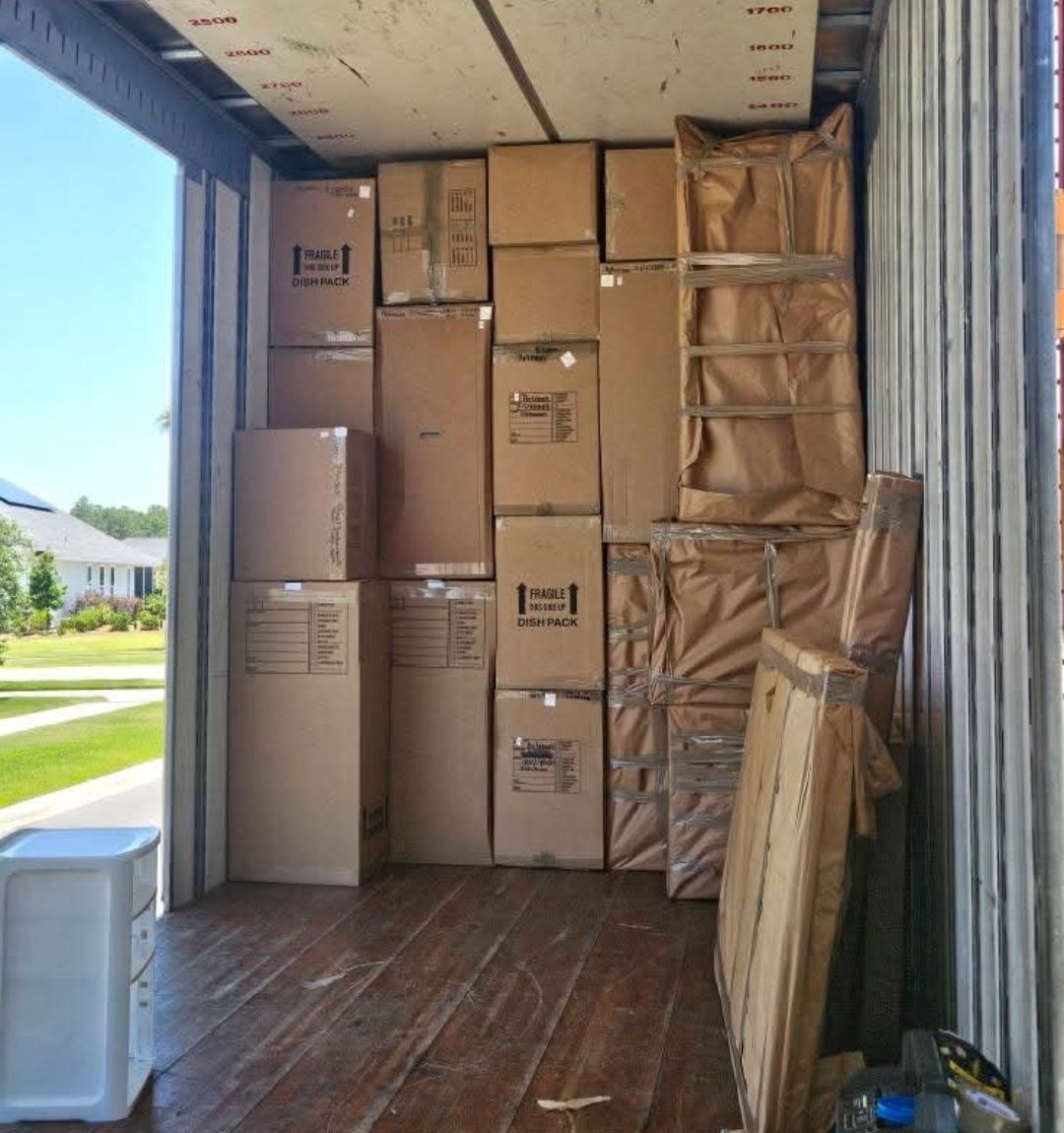 Dish-pack and fragile boxes loaded at residential home exterior — One World Van Lines DFW Metroplex professional movers