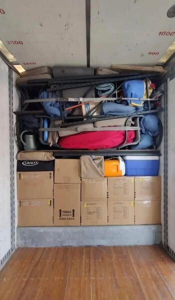 Moving truck loaded with Graco baby gear, dish-pack fragile boxes, camp chairs, strollers and cooler for family move — One World Van Lines Coppell, TX DFW Metroplex family movers