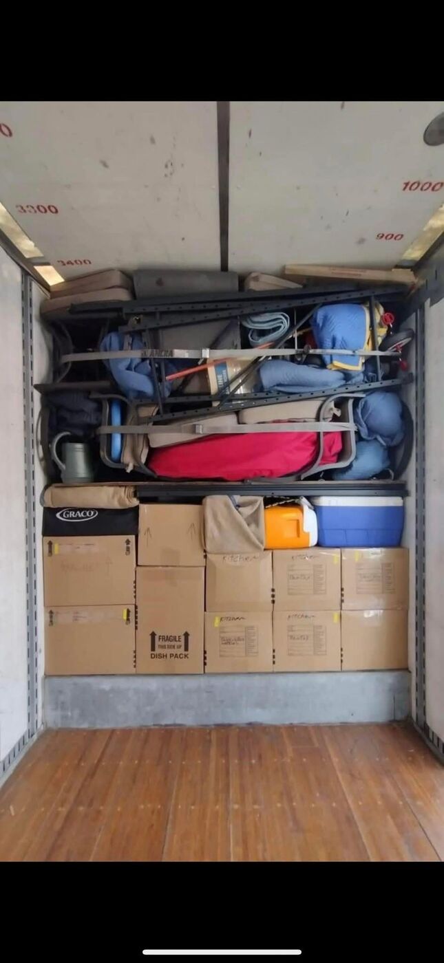Moving truck packed with Graco baby gear, dish-pack fragile boxes, folding camp chairs, cooler and household items for family move — One World Van Lines Mansfield, TX DFW Metroplex