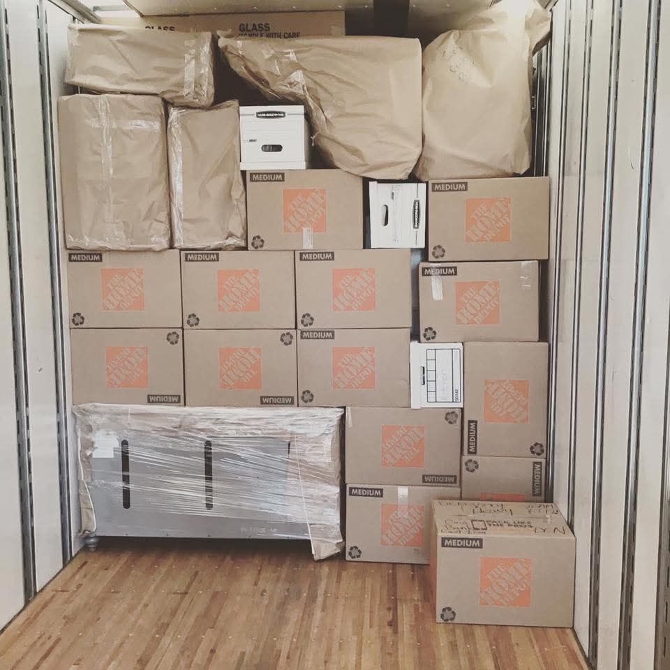 Home Depot medium boxes and glass-labeled fragile items packed floor to ceiling in moving truck — One World Van Lines Dallas–Fort Worth