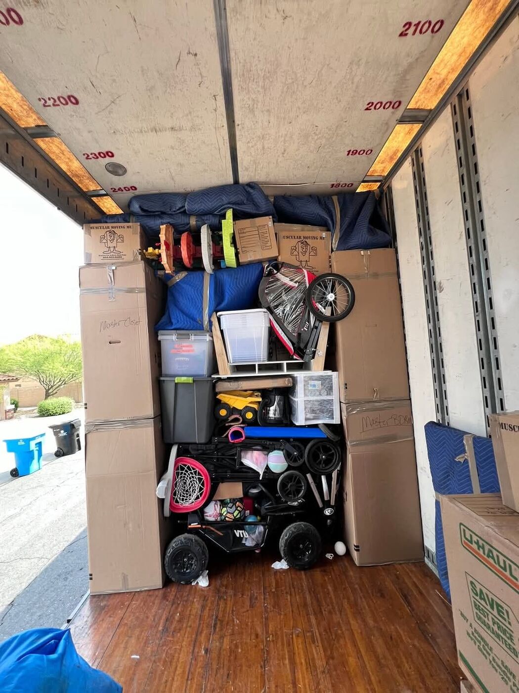 Moving truck loaded with kids bikes, strollers, toys and household boxes for a family move — One World Van Lines Round Rock, Greater Austin TX professional movers
