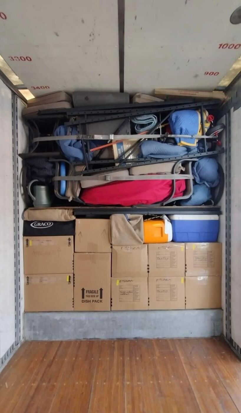 Labeled kitchen and fragile dish-pack boxes loaded in moving truck — One World Van Lines DFW Texas professional movers