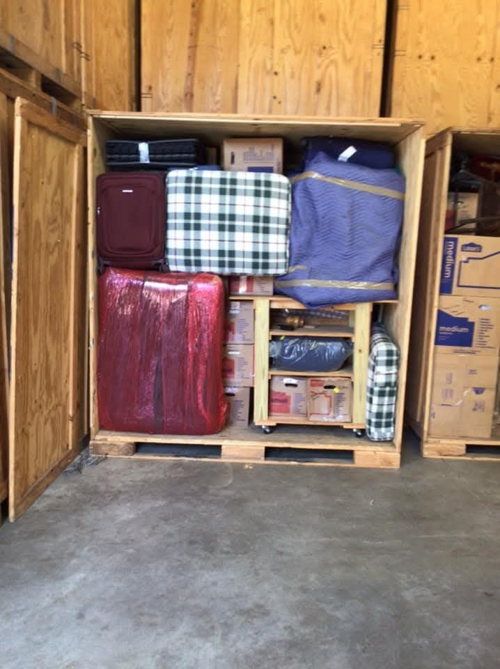Storage vault crate holding luggage, furniture, and household items — One World Van Lines DFW moving and storage company