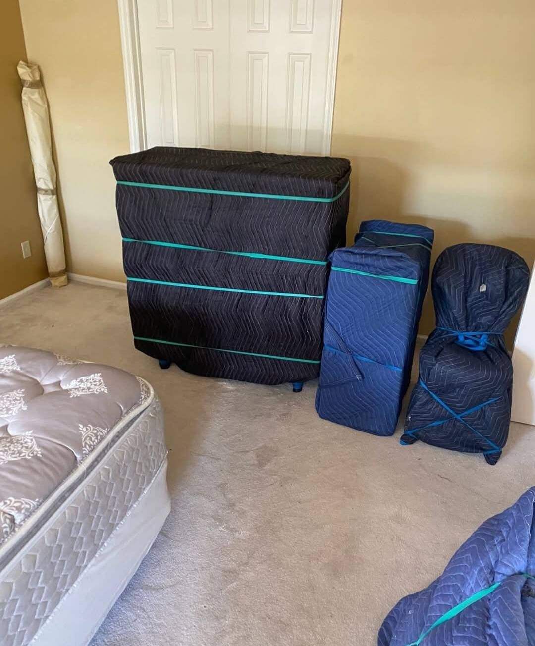 Padded and strapped furniture protection ready for transport — Carrollton, TX movers