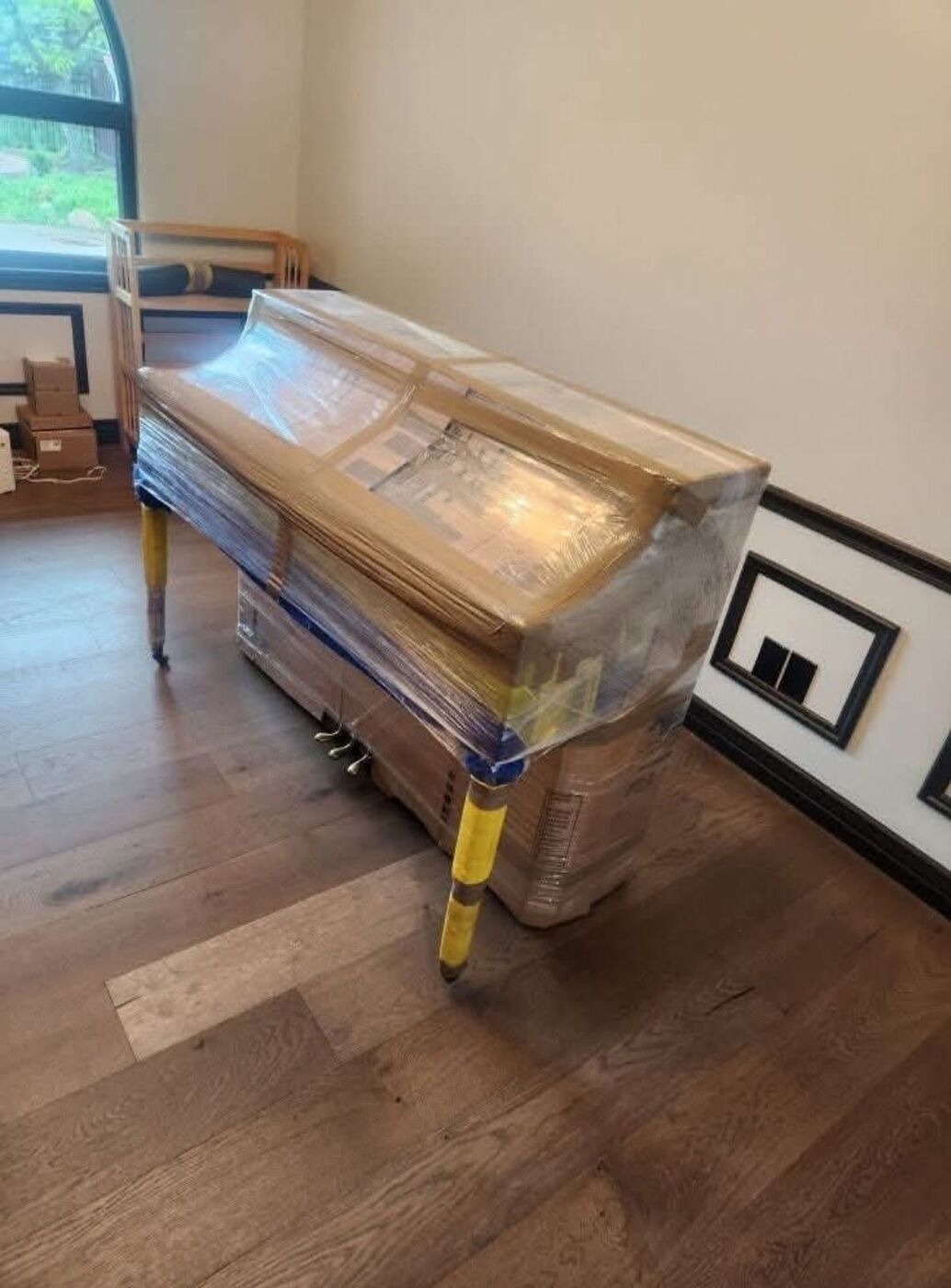 Grand piano wrapped and secured for specialty moving service — Dallas, TX