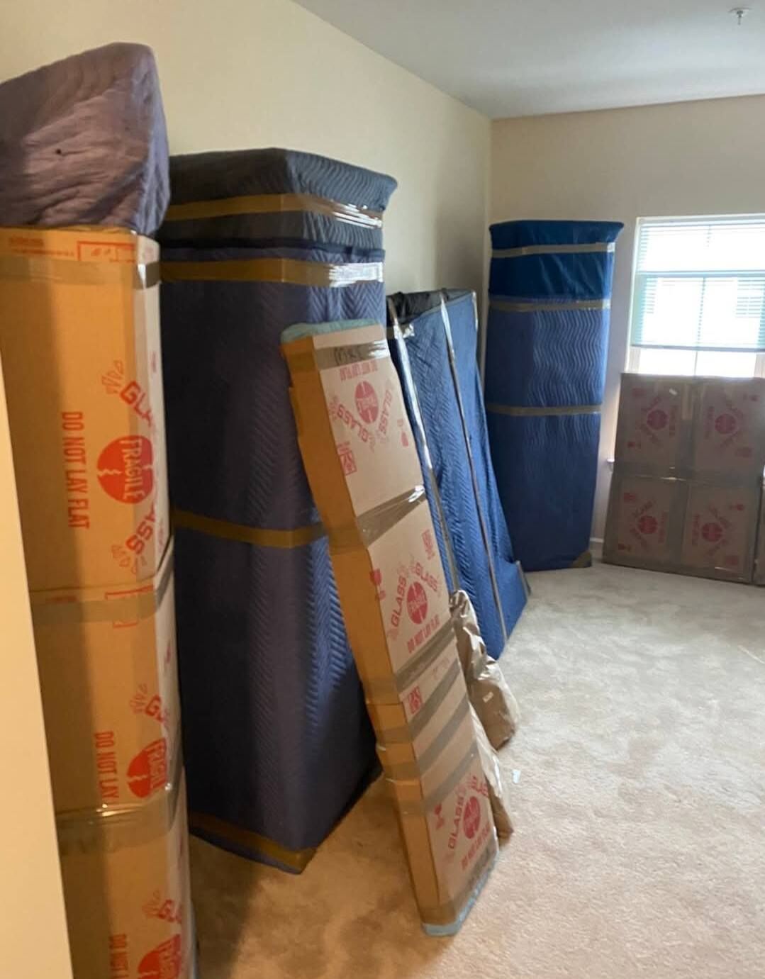 Professional furniture wrapping with moving blankets — DFW movers protecting items